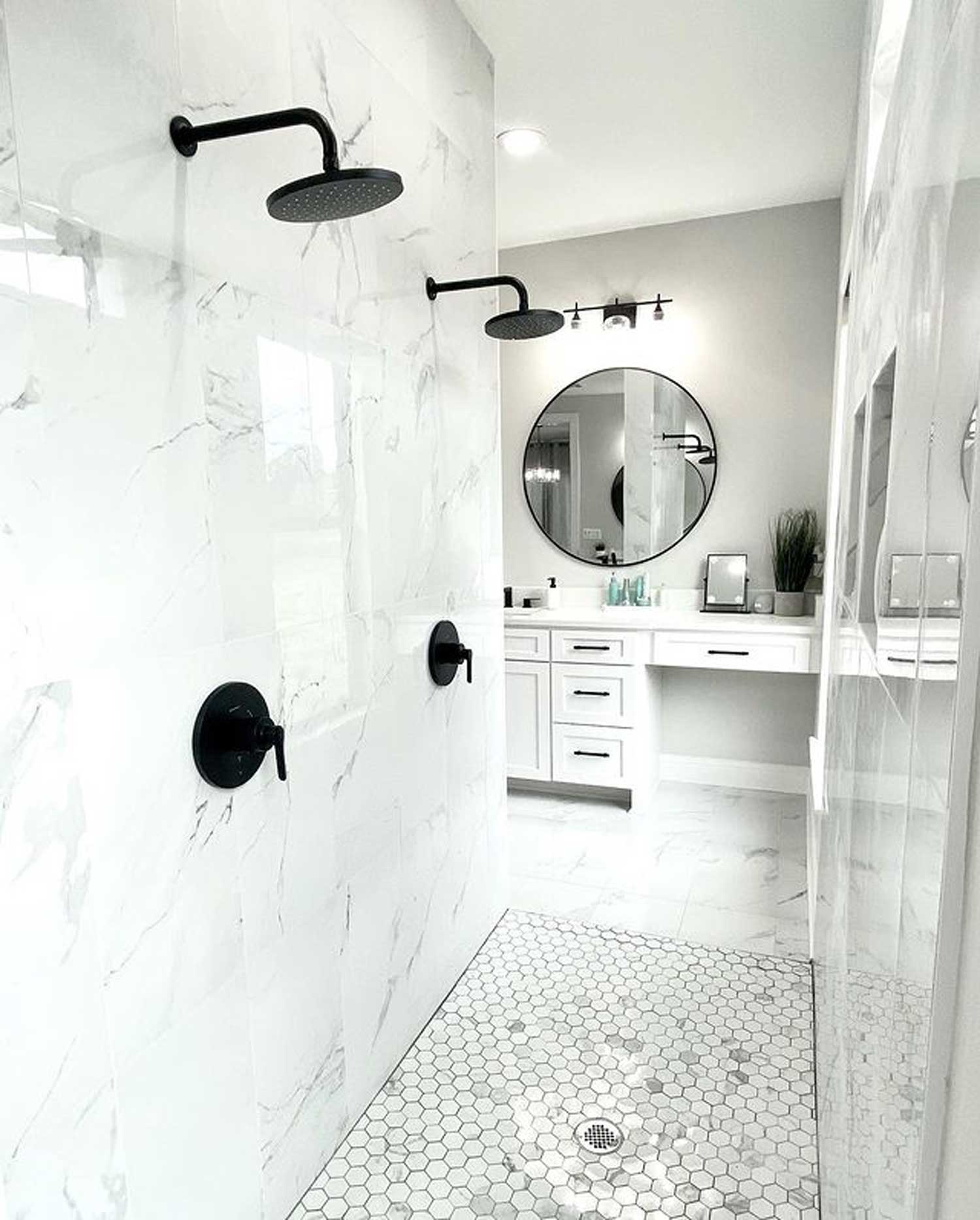 White marble tiled shower with two showerheads